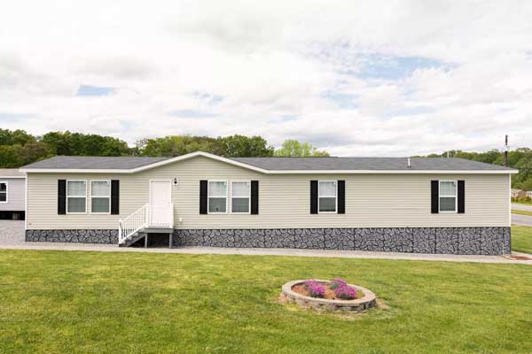 Mobile home with stone skirting, showcasing a prime candidate for refinance through 21st Mortgage.