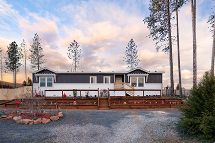Front of a manufactured home with landscaping beds