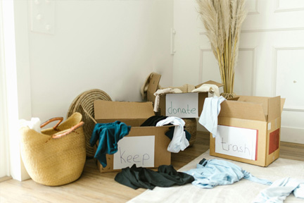 Boxes of belongings marked keep, donate, and trash